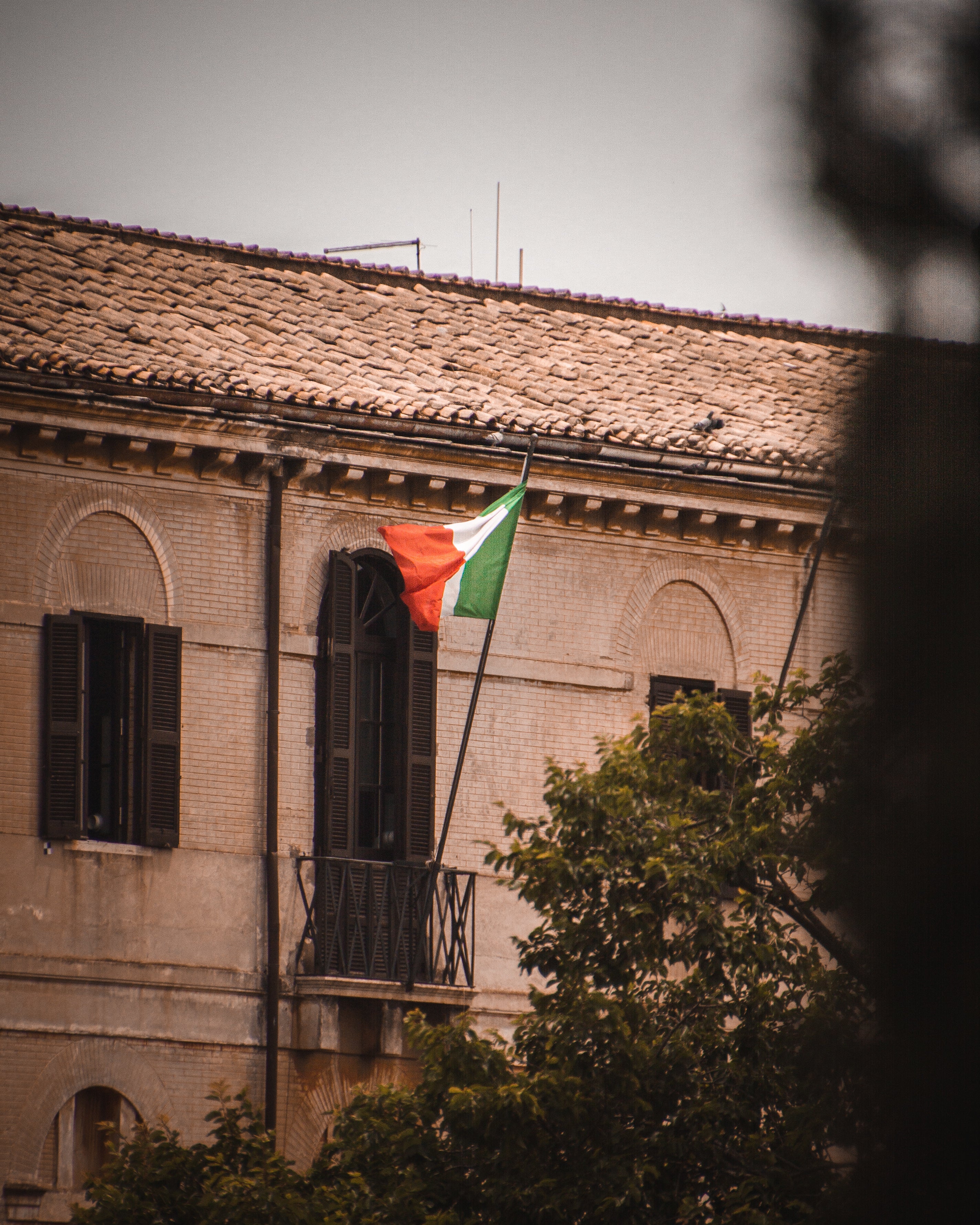 an-italian-flag-billows-from-a-balcony.jpg